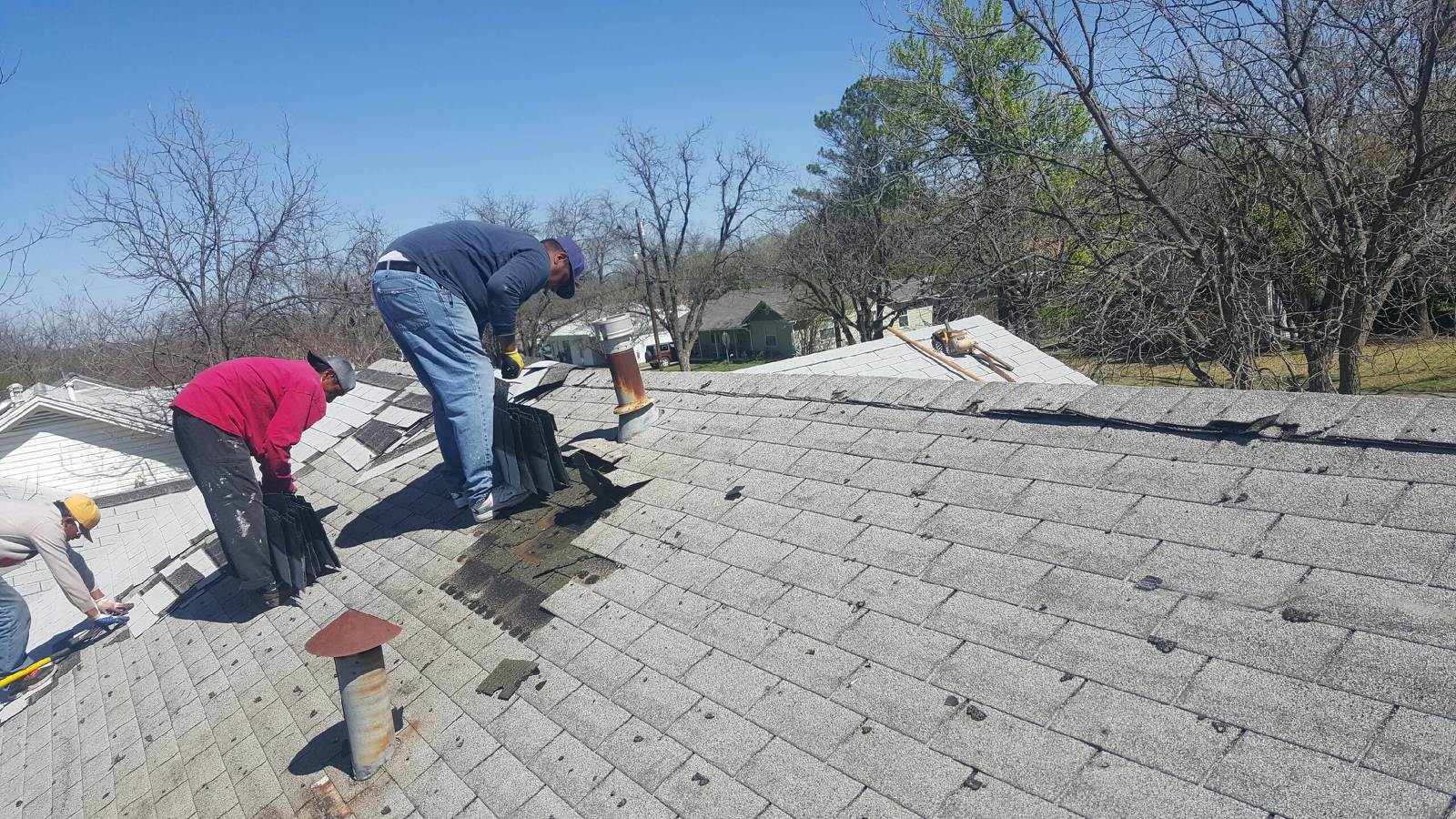 Heritage Roofing crew performing full roof tear-off and replacement in Central Texas