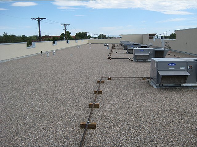 Granulated built-up gravel flat roof with HVAC equipment — commercial flat roofing Central Texas