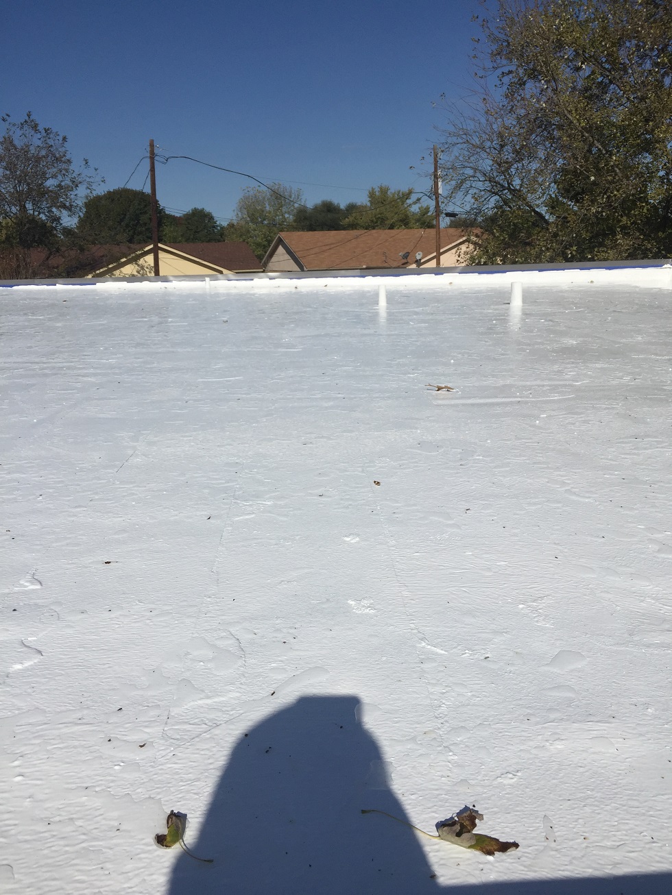 Wide commercial TPO flat roof with pipe penetrations — Heritage Roofing Central Texas