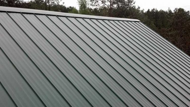 Green standing seam metal roof on residential building — Heritage Roofing metal roofing TX