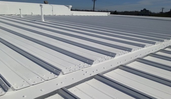 White standing seam metal roof with turbine ventilation — Heritage Roofing skylights and ventilation TX